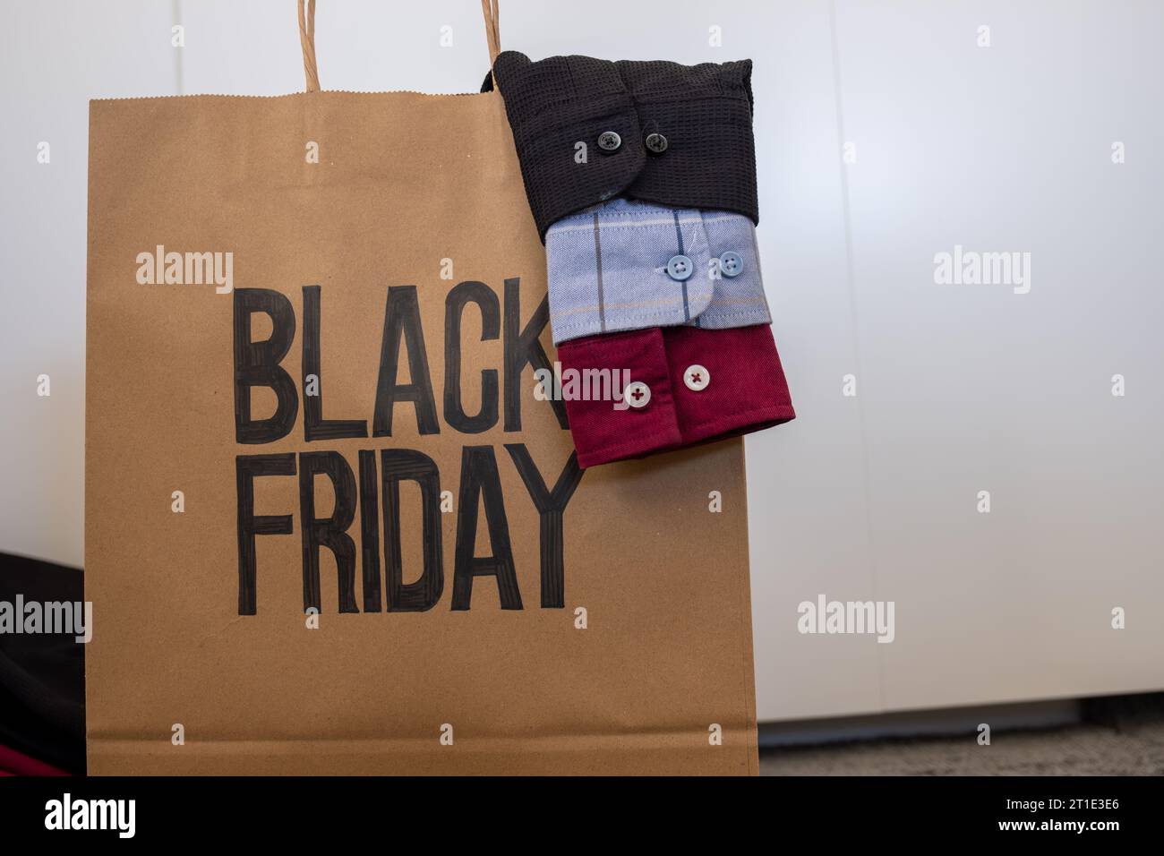 Shirt sleeve with shopping bag represents clothes sales for black friday and white friday with mock up space or free space Stock Photo