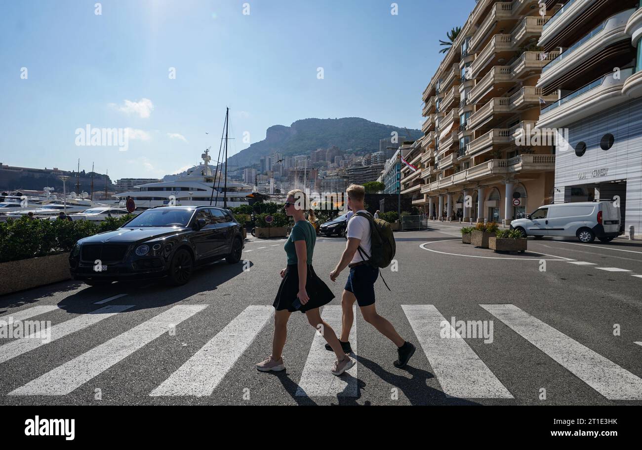 Pedestrians walk through the Nouvelle Chicane on the Monaco Grand Prix circuit in it's non race configuration. Stock Photo