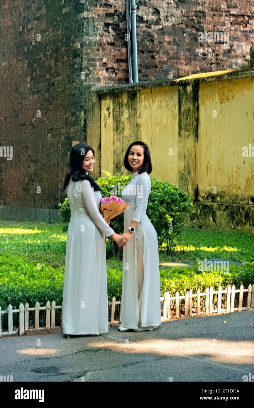 Women in ao dai at Cua Bac (Hanoi citadel) on Phan Dinh Phung Street, Hanoi, Vietnam Stock Photo