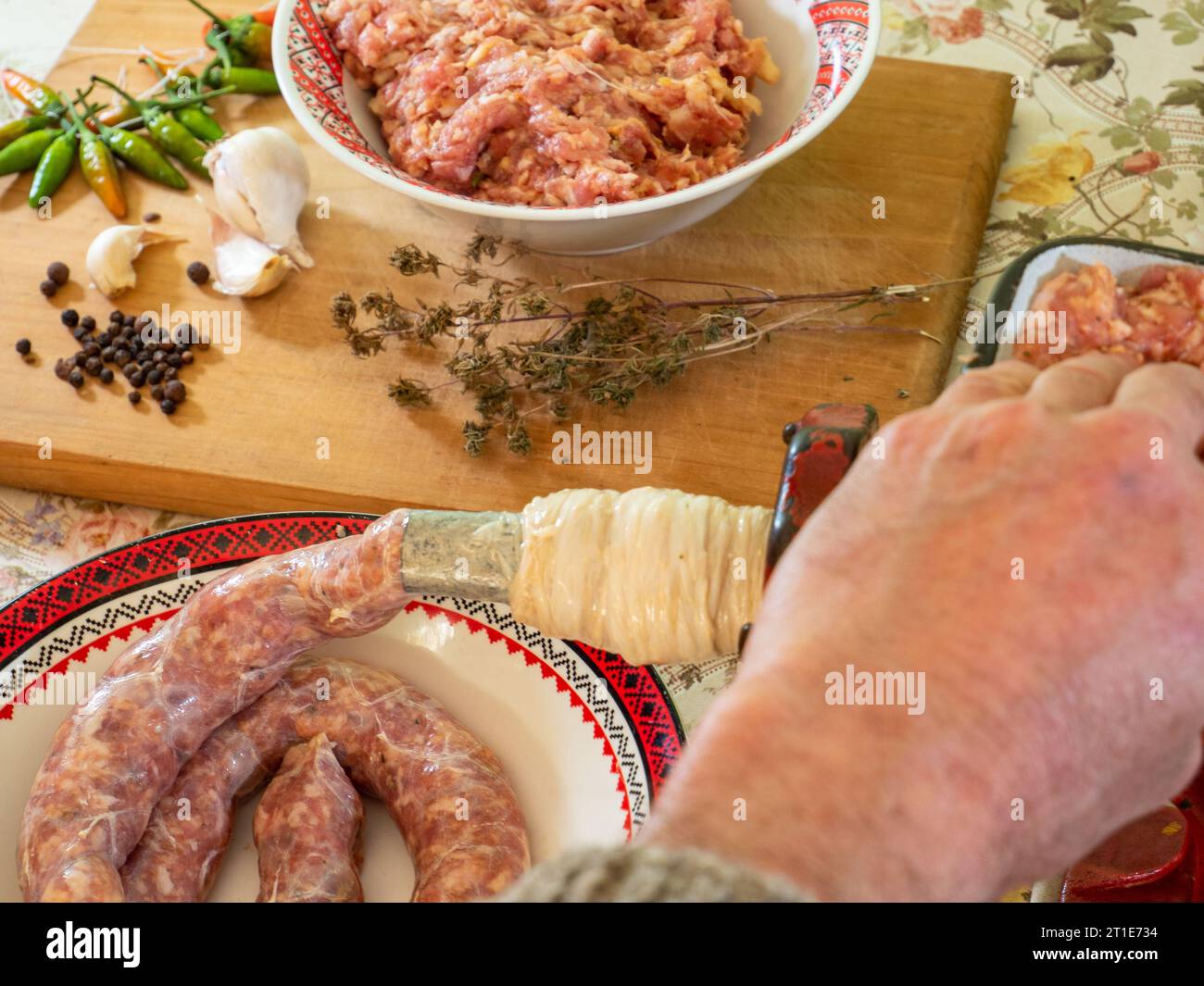 man making sausages the traditional way using sausage filler Stock
