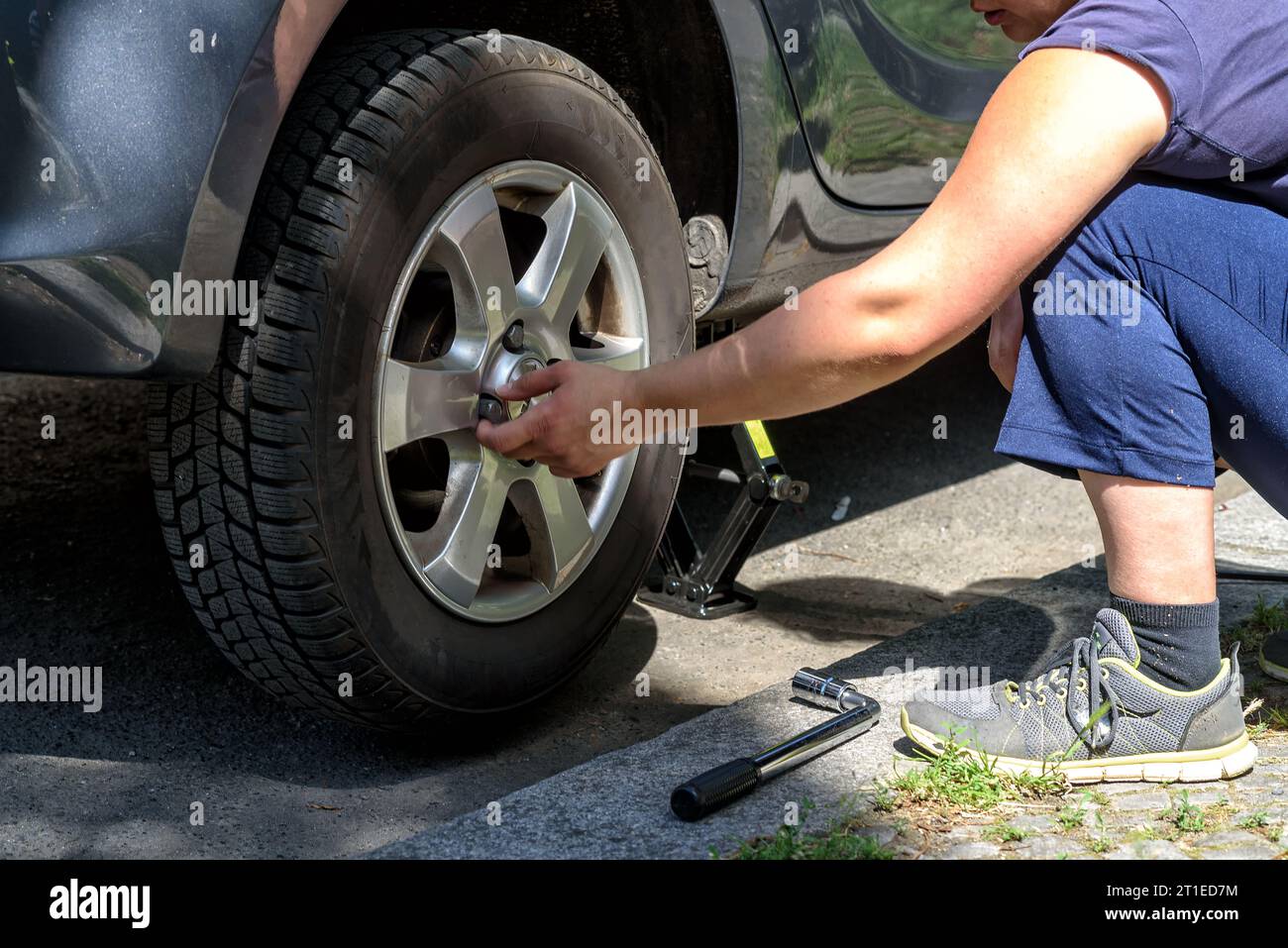 changing the tires of a car from  winter tires to summer tires in spring Stock Photo