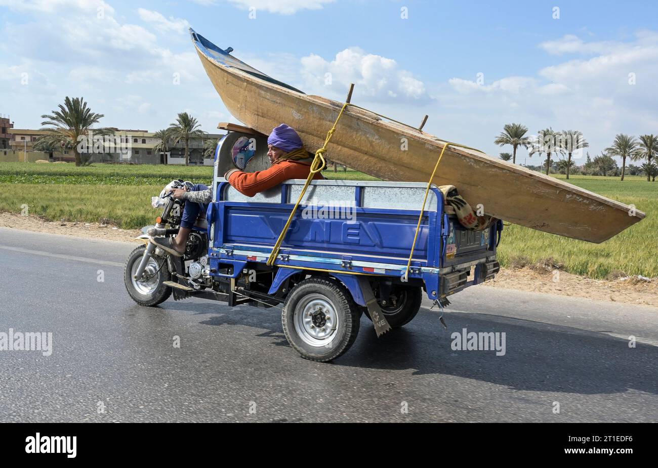 EGYPT, Fayoum, boat transport on tri-bike / ÄGYPTEN, Fayoum, Transport eines Bootes auf Lastendreirad Stock Photo