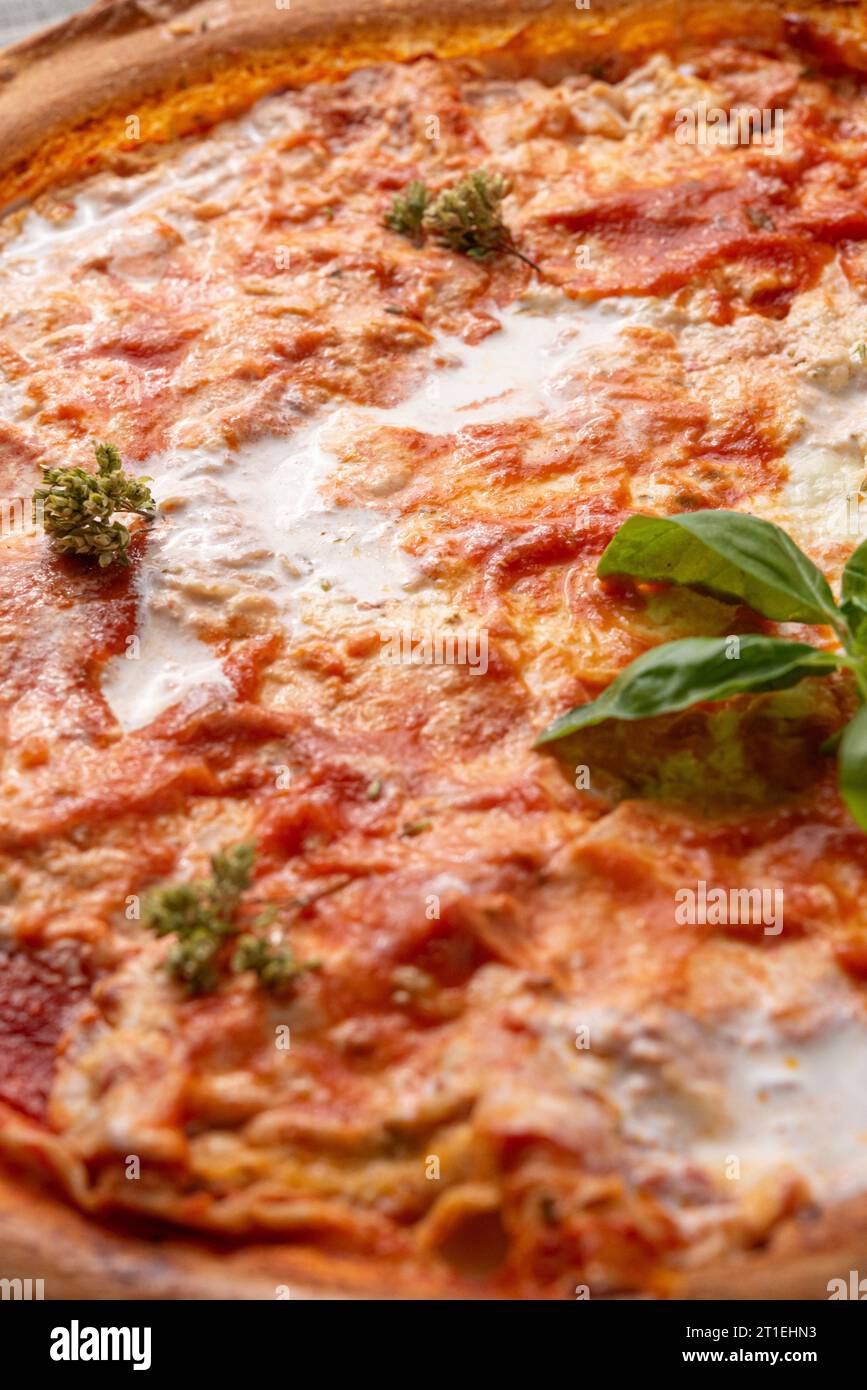 Thin pizza crust with tomato sauce and soft cheese Stock Photo