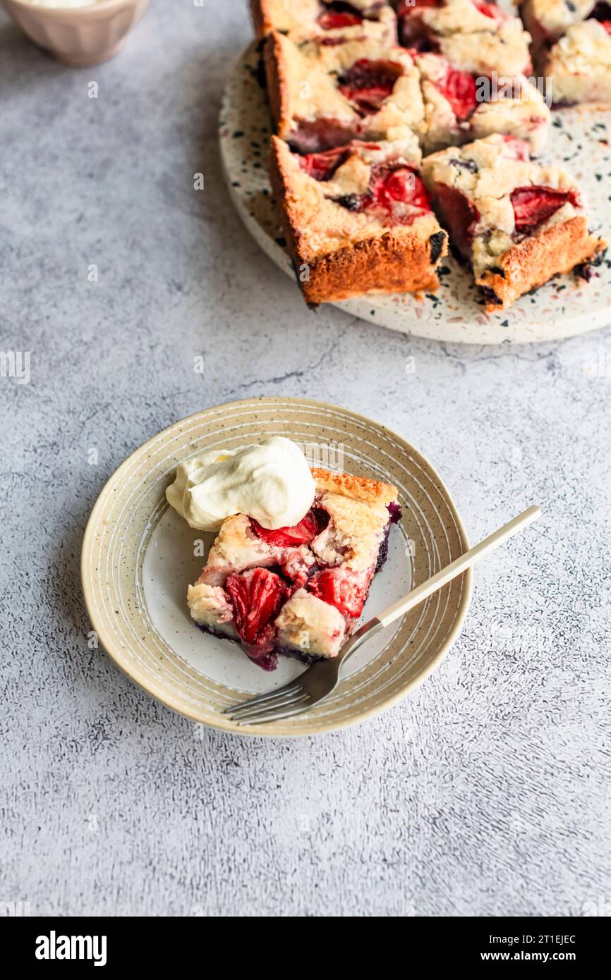 Strawberry blueberry sheet cake with coconut milk and coconut flakes Stock Photo