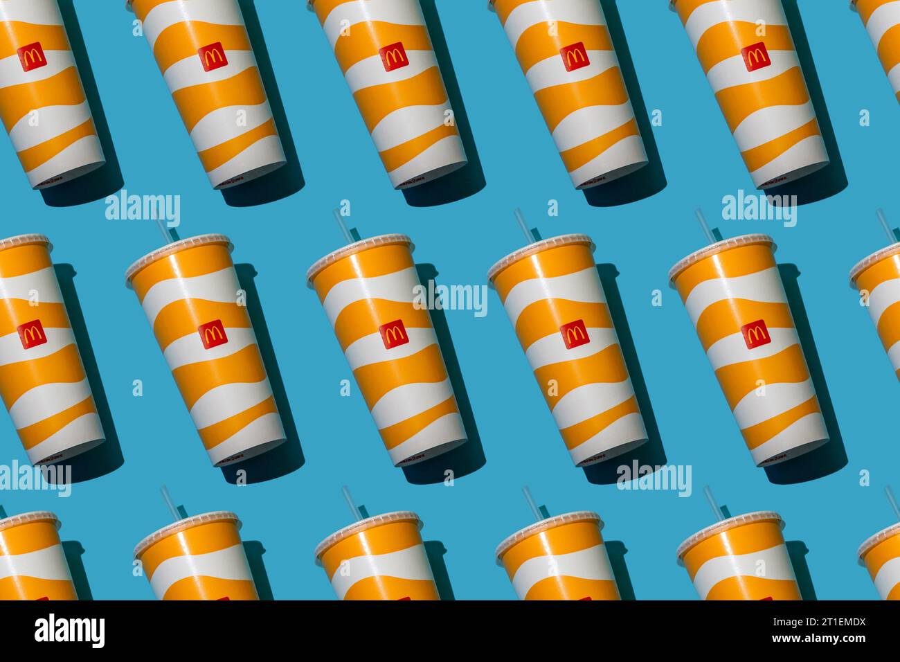 Yellow glass of McDonald's. Paper cup with lid. Takeaway drink ...