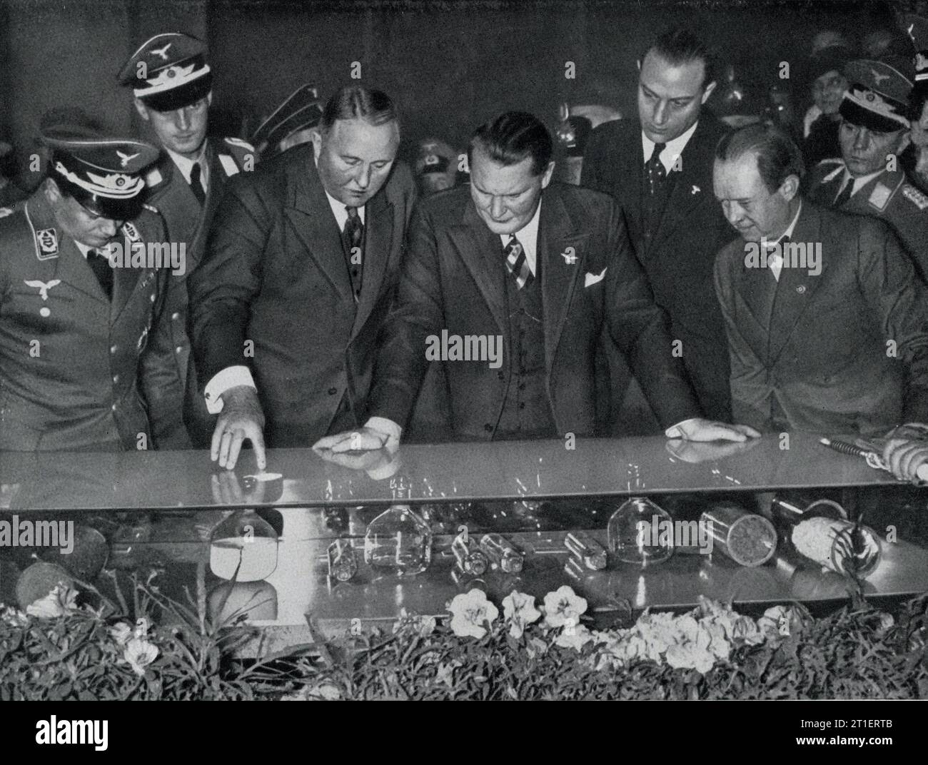 President of the Reich Association of the Motor Industry Dr. ALLMERS and Major General UDET with HERMANN GORING / GOERING examining synthetic rubber exhibits at the INTERNATIONALE AUTOMOBIL  UND MOTORRAD AUSTELLUNG / INTERNATIONAL CAR AND MOTORCYCLE EXHIBITION in Berlin Germany which ran from 20th February to 7th March 1937 Stock Photo
