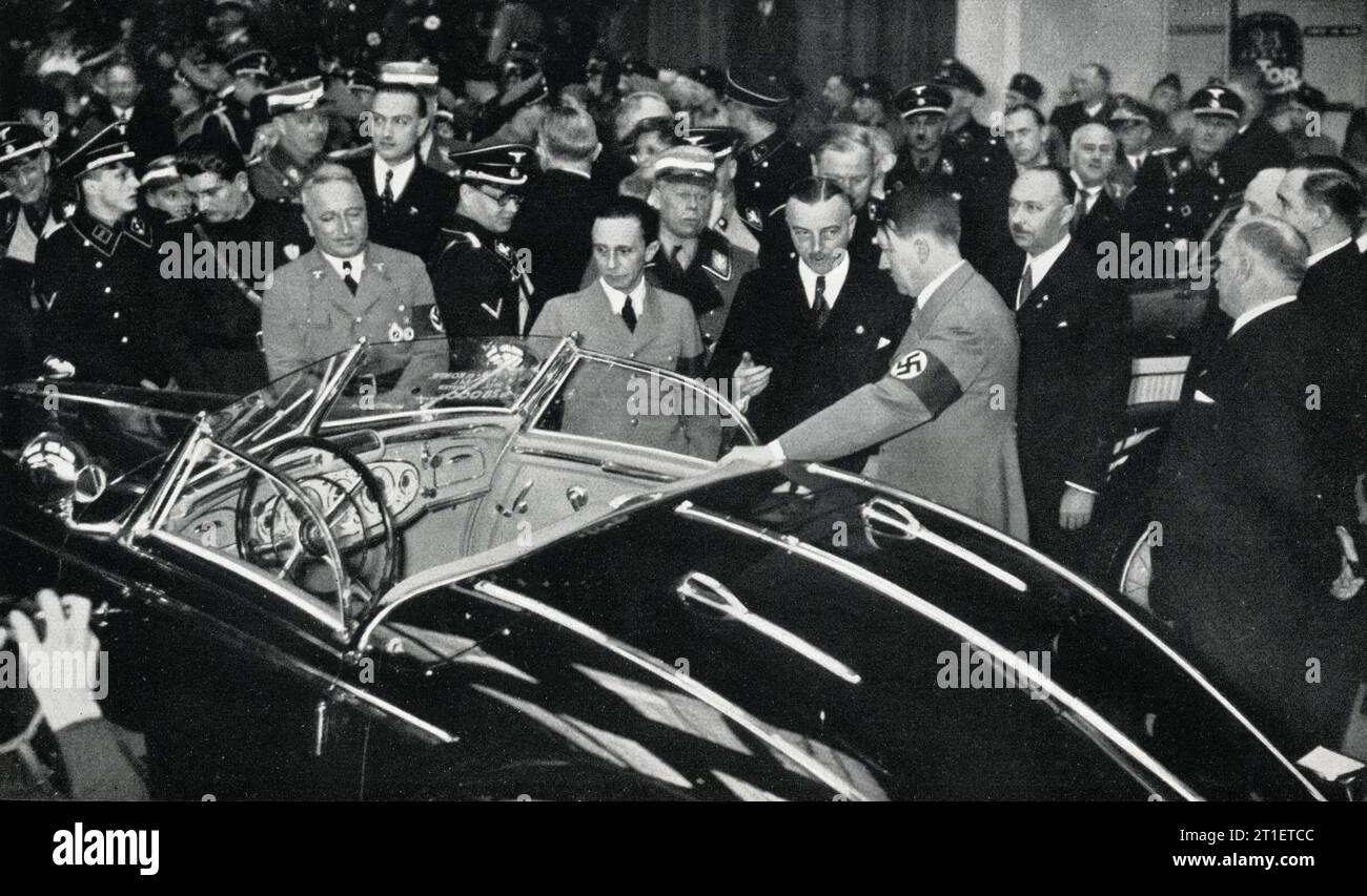 Dr. JOSEPH GOEBBELS Dr. ROBERT LEY (and behind him Italian Workmen's Leader Signor TULLIO CIANETTI ) and ADOLF HITLER visiting the INTERNATIONALE AUTOMOBIL  UND MOTORRAD AUSTELLUNG / INTERNATIONAL CAR AND MOTORCYCLE EXHIBITION in Berlin Germany which ran from 20th February to 7th March 1937 Stock Photo