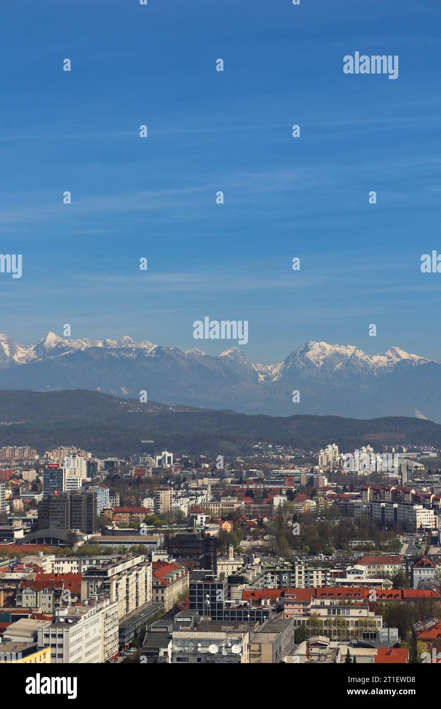 Aerial view of Ljubljana taken from Ljubljana Castle (Ljubljanski grad). In the background, the Grintovec mountain range. Photo taken in April 2022 Stock Photo