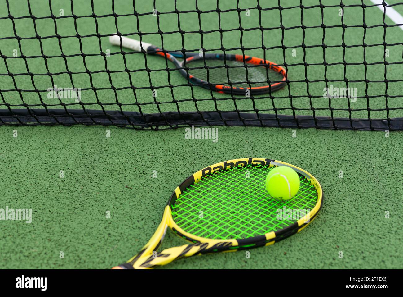 tennis racket next to a ball and line Stock Photo
