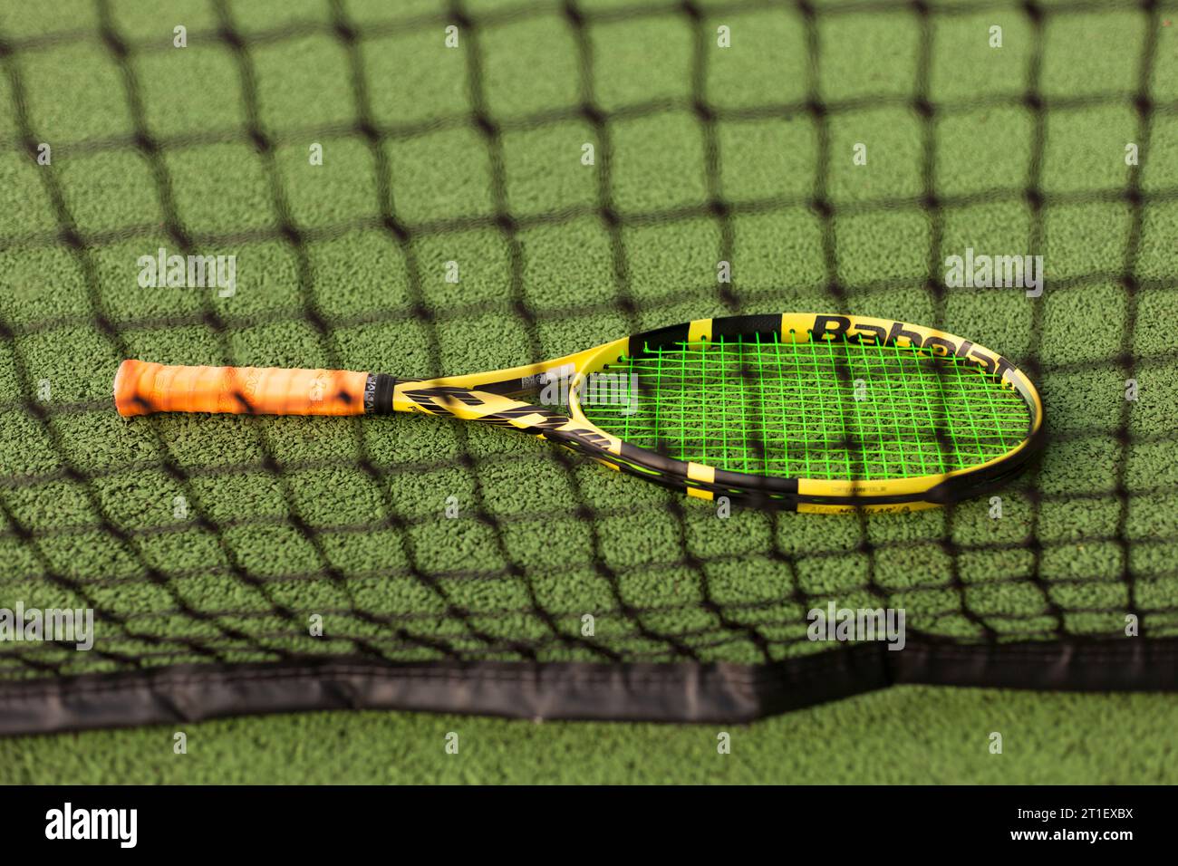 Tennis racket seen through net Stock Photo Alamy