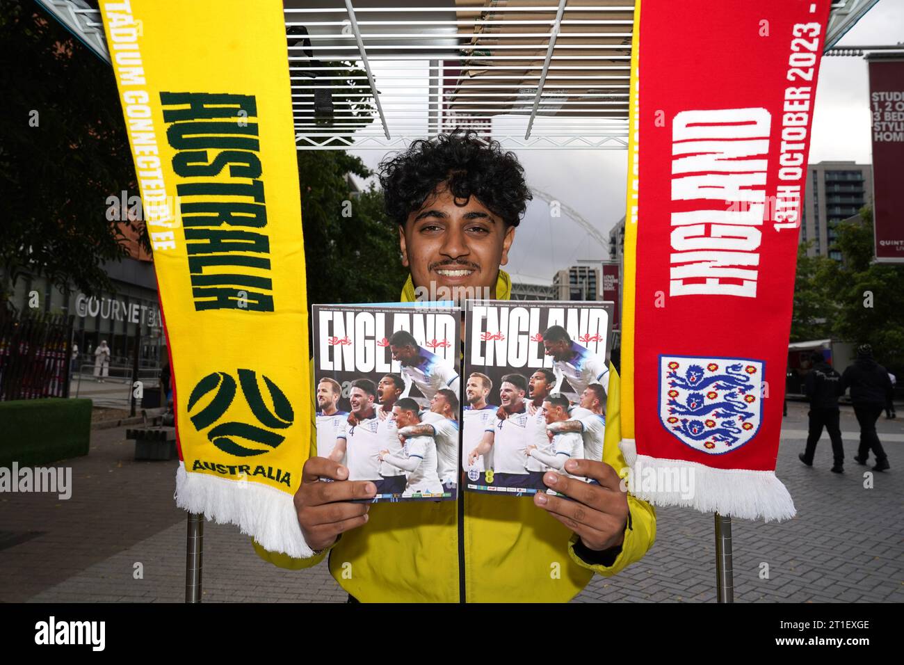 A vendor sells matchday programmes ahead of the international friendly ...