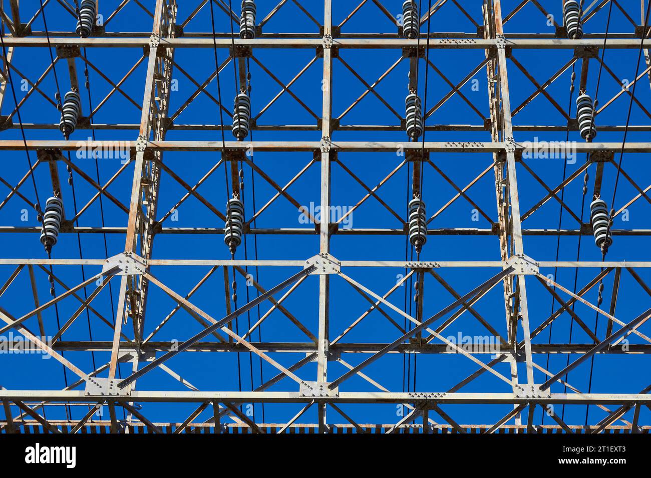 Overhead High Voltage Electrical Power Transmission Cables And Insulators On An Pylon (Transmission Tower) Stock Photo