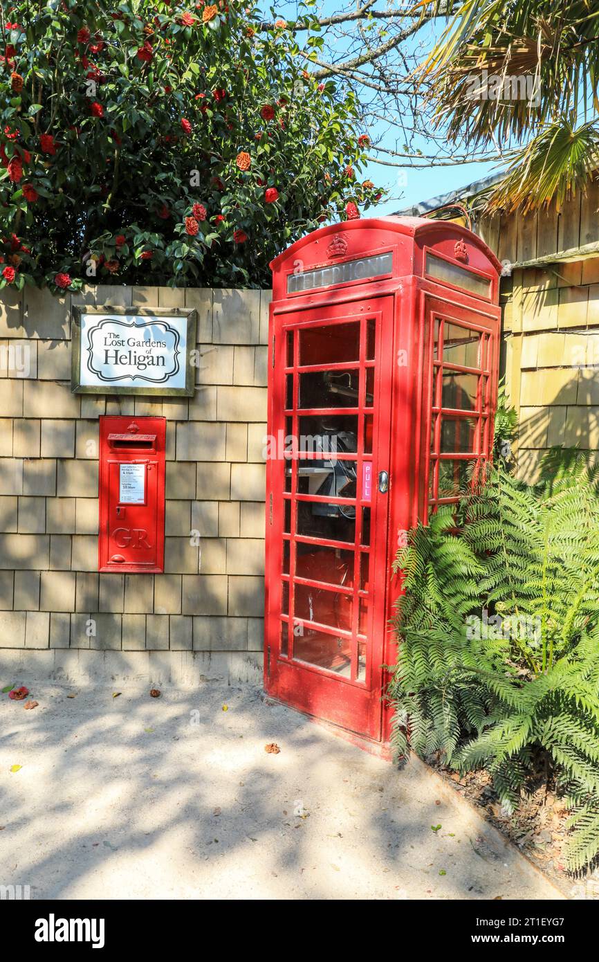 A red post box or letterbox and a red telephone kiosk or telephone box at the Lost Gardens of Heligan Cornwall April 2021 Stock Photo