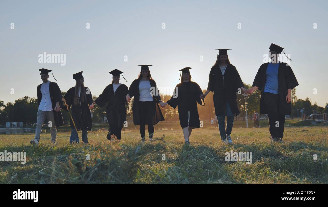 College graduates walk sunset hi-res stock photography and images - Alamy