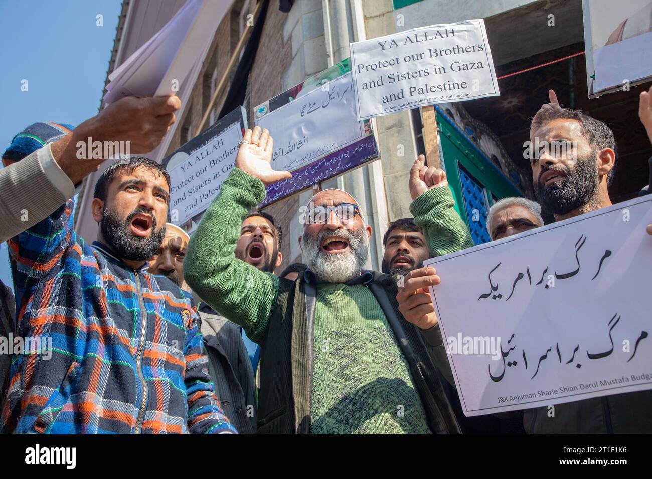 Kashmiri Muslims hold placards while chanting slogans during a ...