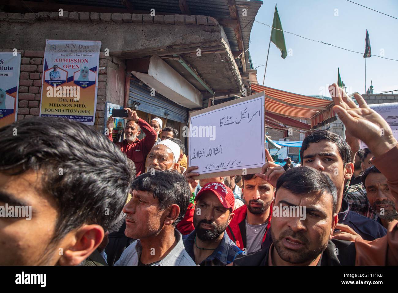 A Kashmiri Muslim holds a placard during a demonstration in solidarity ...