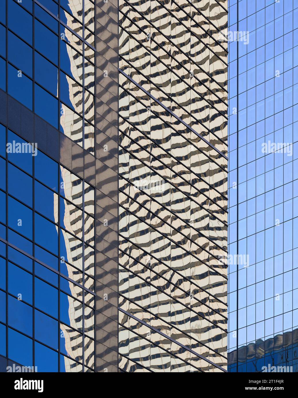 Architectural abstract of colorful reflections off glass walls of modern skyscrapers on Adelaide Street in downtown Toronto, Ontario Stock Photo