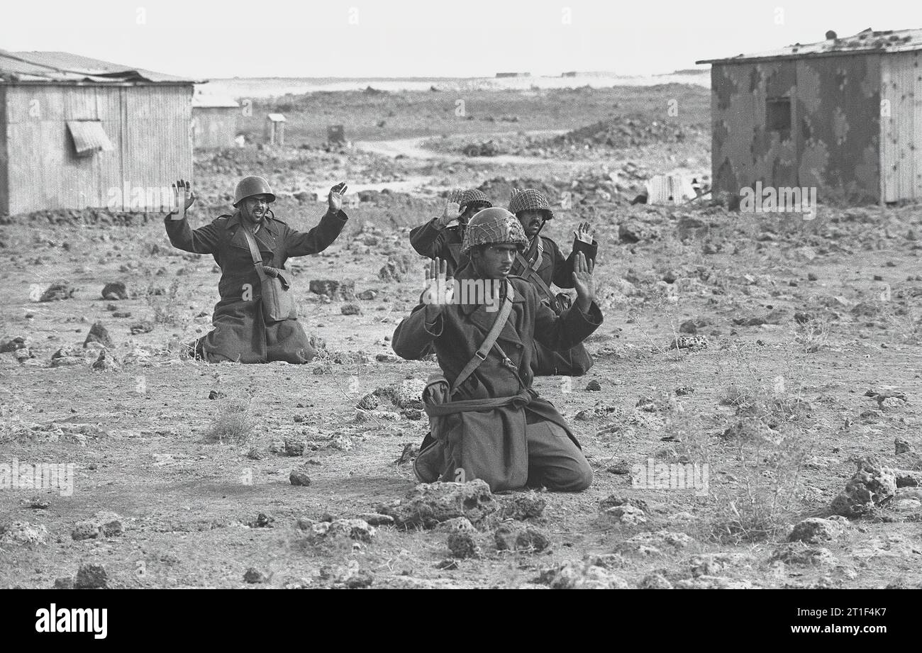 SYRIAN SOLIDERS HOLDING THEIR HANDS UP AS A SIGN  OF SURRENDER IN THE GOLAN HEIGHTS, DURING THE YOM KIPPUR WAR Stock Photo