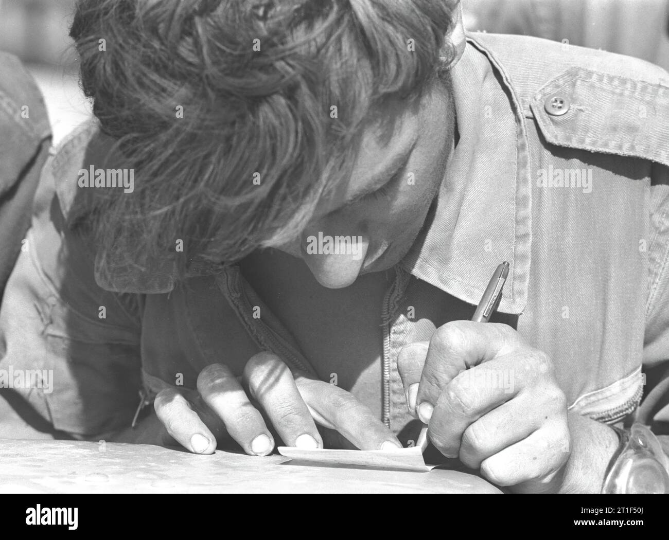YOM KIPPUR WAR. SOLDIER WRITING A LETTER HOME. IDF photograph by ARAD