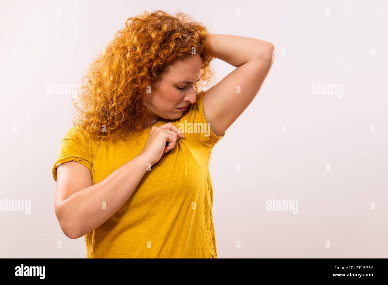 Ginger woman is sweating to much and she doesn't like her smell under