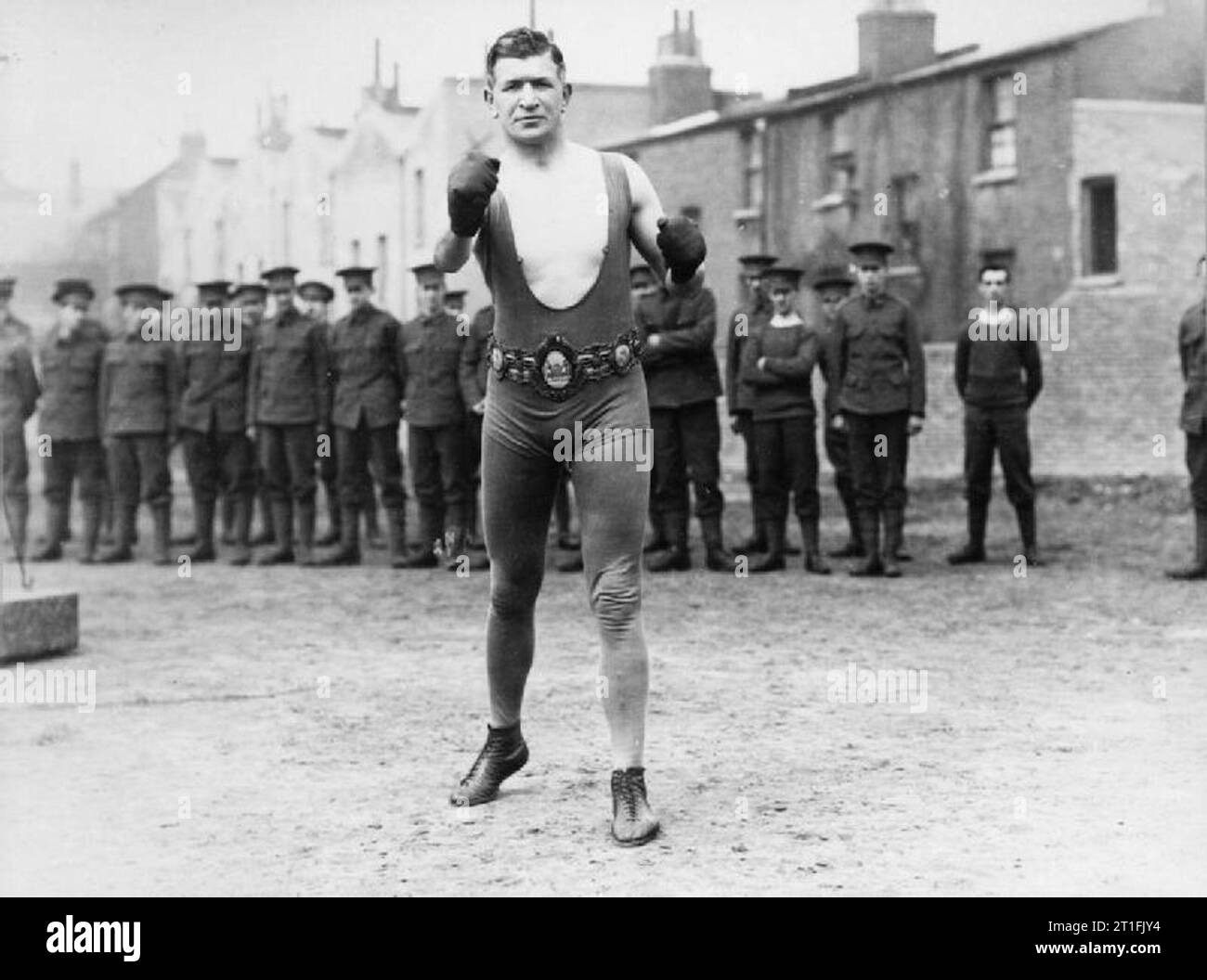 . Instructor, Boxing Platoon L/Cpl O'Keefe, English Middle Weight Boxing Champion and holder of the Lonsdale Belt, assisting with training men of 1 Battalion, Surrey Rifles at Camberwell. O'Keefe was born in London in 1883 and began his boxing career in 1906. Between 1907 and 1911, he pursued his boxing career in Australia. In May 1914, he won the Middle Weight Title by defeating Jim Sullivan. During the war, he served as a Physical Training Instructor but also won several bouts. In 1915, he knocked out Bandsman Jack Blake in Round 13 and defeated Jim Sullivan again in 1916. In a return match Stock Photo