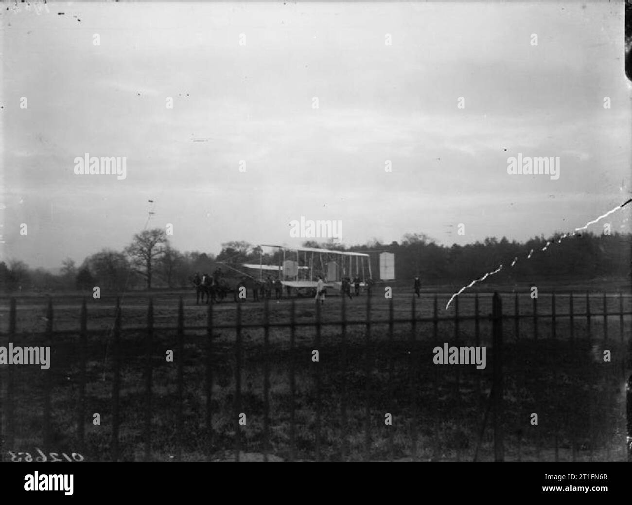 Aviation in Britain Before the First World War Cody aircraft mark IB on the ground. Soldiers with a horse and cart are standing by. In the foreground are a set of metal railings. With this mark additional elevator surfaces were added either side of the original elevator's and the biplane lifting tail was removed. Particularly with his earlier aircraft Cody made constant adjustments to the arrangement of the flying surfaces, often after crashes, in order to obtain better performance and handling. These changes mean that identifying specific sub-marks of Cody aircraft can at times be very diffic Stock Photo