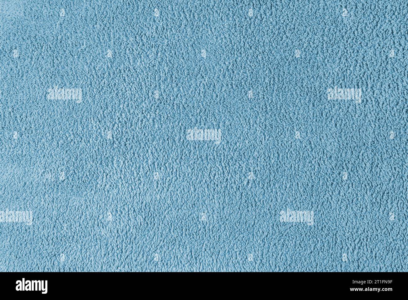 Terry cloth, blue towel texture background. Soft fluffy textile bath or beach towel material. Top view, close up. Stock Photo