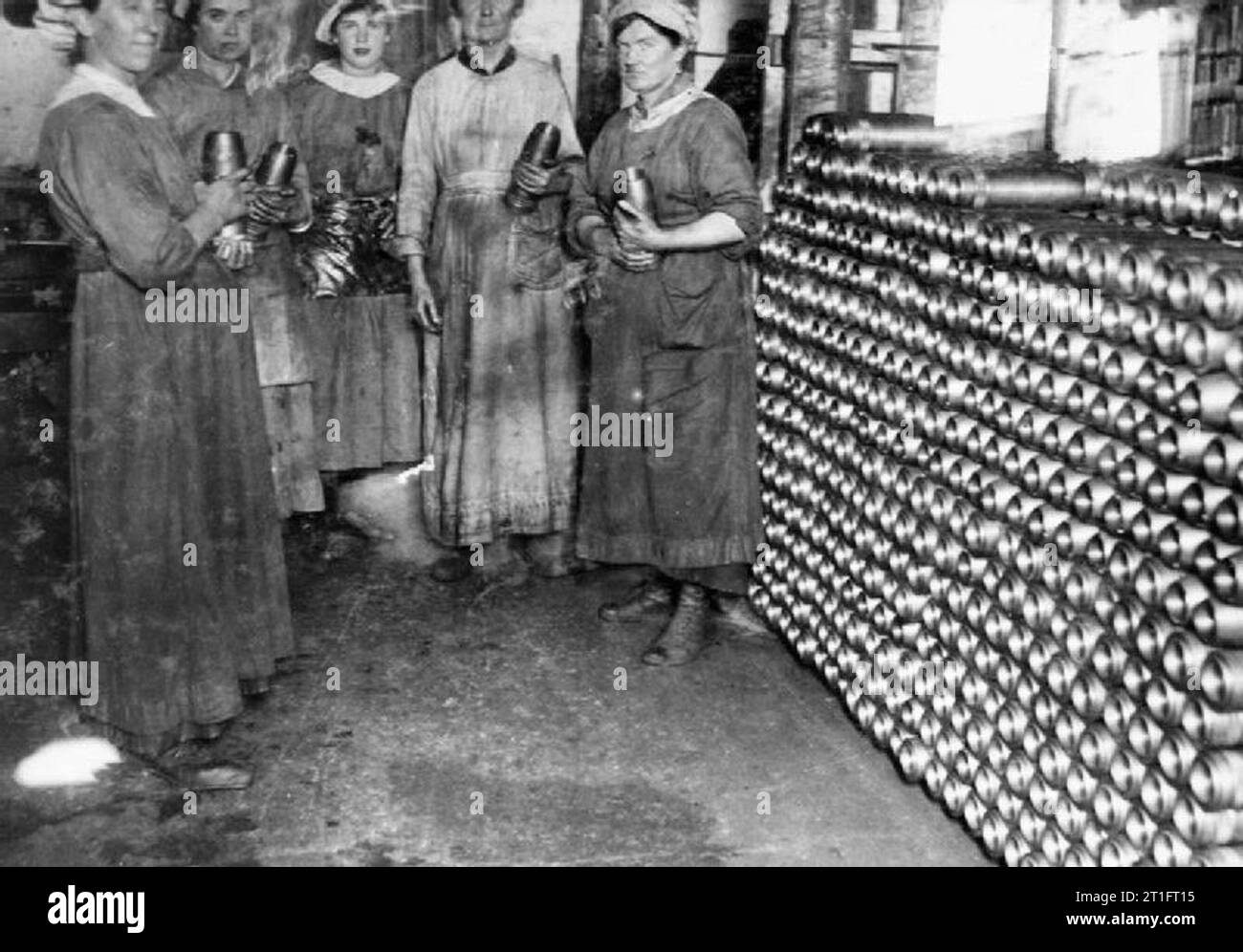Industry during the First World War Female workers hold shells they are stacking in a British munitions factory during the First World War. Stock Photo
