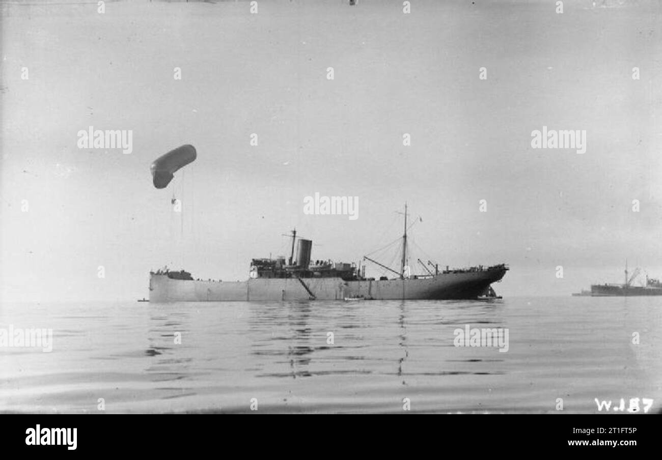 The kite balloon ship HMS Canning with her observation balloon anchored off Salonika with kite balloon aloft, November 1915.D&W Henderson of Glasgow built the ship in 1896 as a cargo ship for Lamport & Holt Line. She was a transport ship in the Second Boer War 1899–1900. The Admiralty bought her in 1915 and commissioned her as a kite balloon ship. In 1917 she became a depot ship at Scapa Flow and in 1919 she was returned to Lamport & Holt. In 1920 Mrs G Visalia bought her, renamed her Okeanos and registered her in Piraeus. In 1924 Ditta Luigi Pittaluga Vapori bought her, renamed her Arenzano a Stock Photo