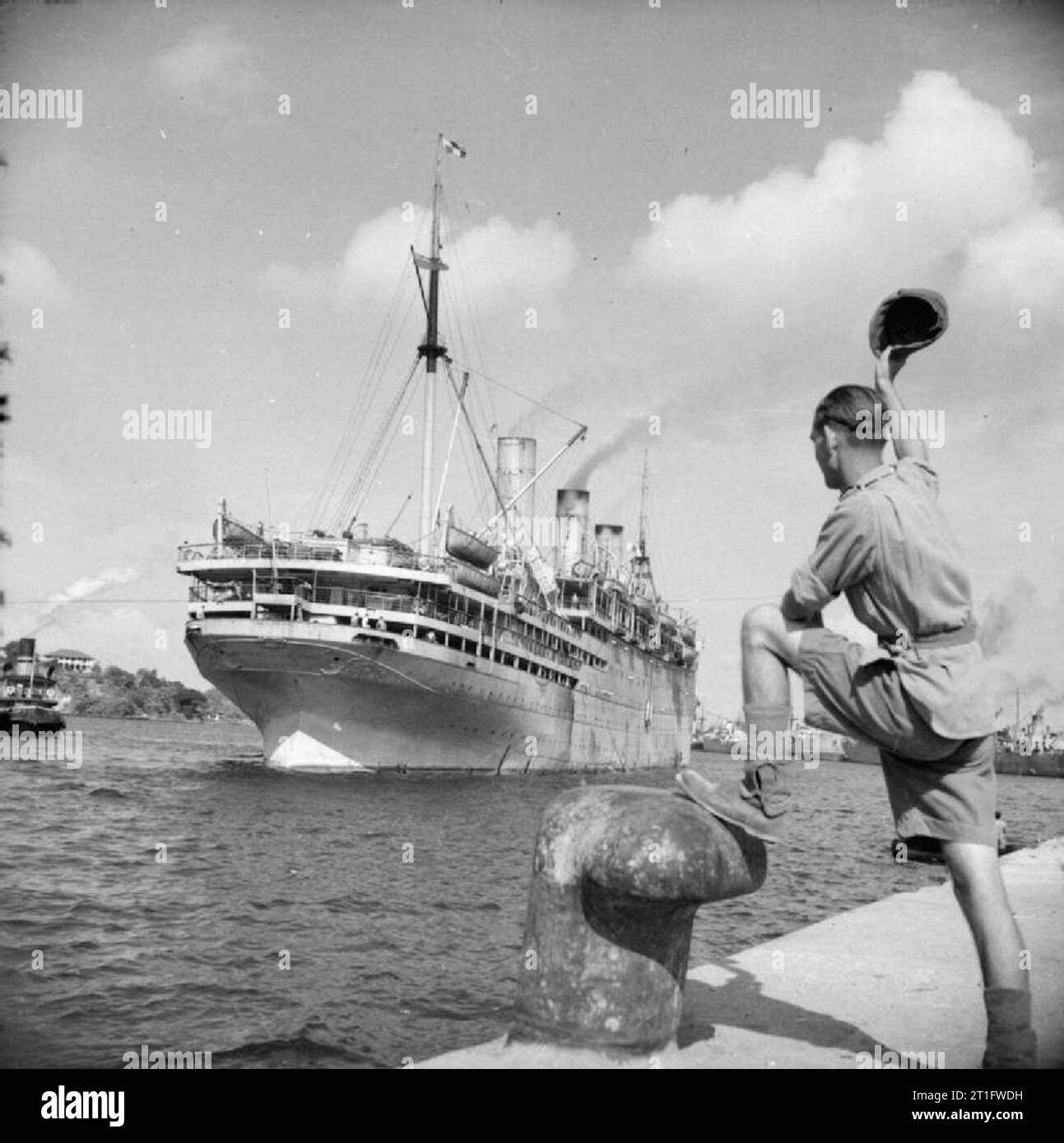 Demobilization of British Service Personnel in the Far East The troopship EMPRESS OF AUSTRALIA leaves No.2 Dock at Singapore carrying British servicemen home for demobilisation. Stock Photo