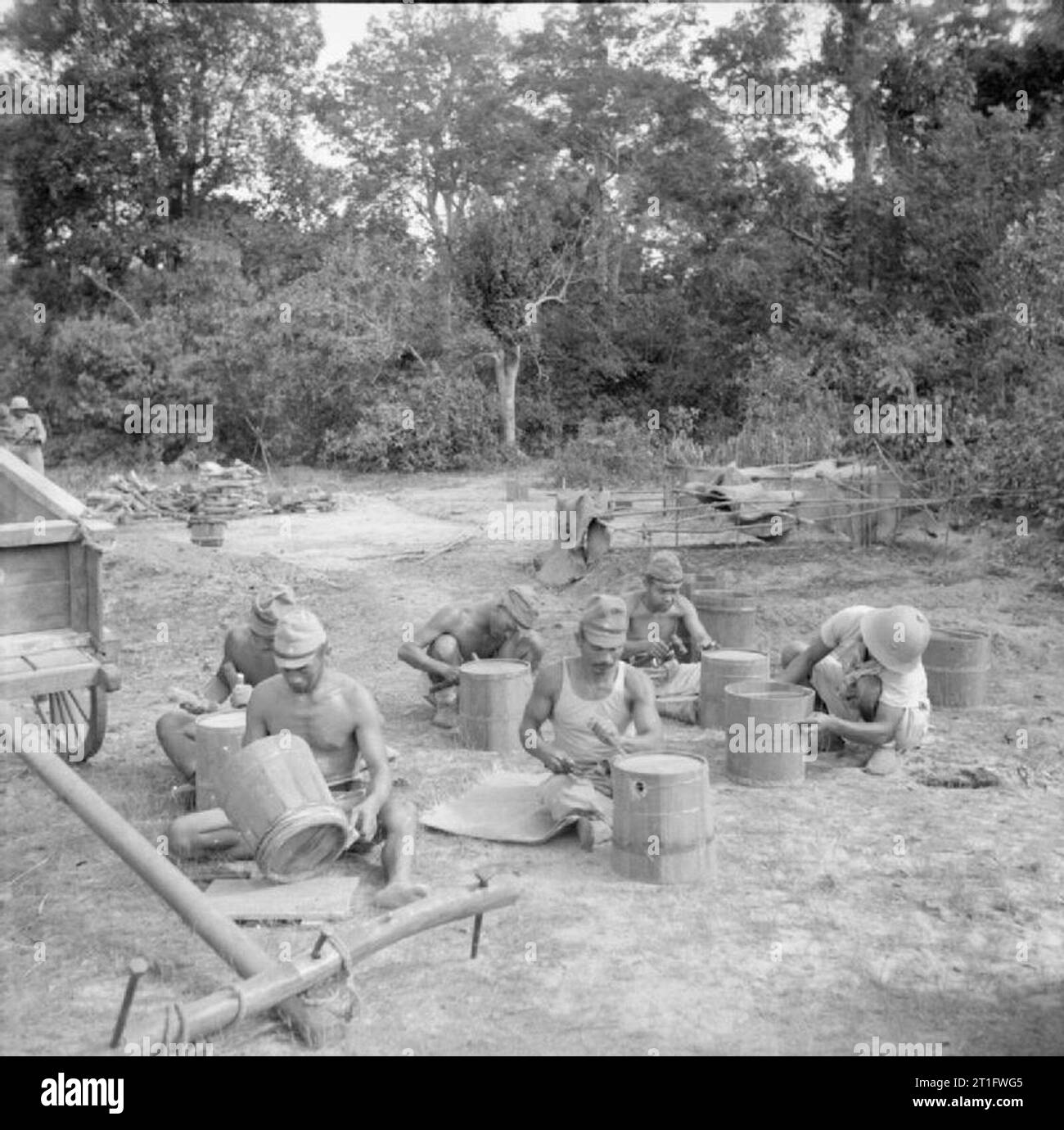 The Allied Reoccupation of French Indo-china Japanese prisoners of war make buckets for use in the camp. Locally cut wood was used to make many of the utensils used around the camp at Cape Saint Jacques, which housed up to 38,500 prisoners. Stock Photo