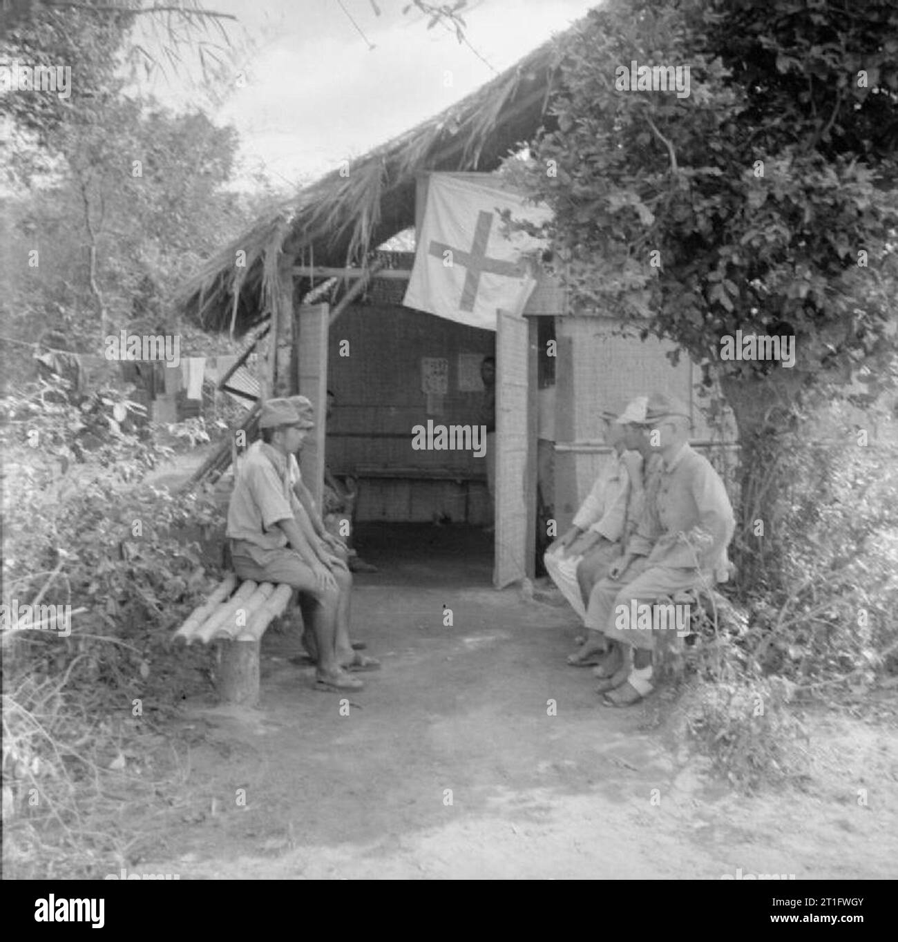 The Allied Reoccupation of French Indo-china Japanese prisoners of war on morning sick parade wait outside the medical officer's hut in the camp at Cape Saint Jacques, which housed up to 38,500 prisoners. Stock Photo