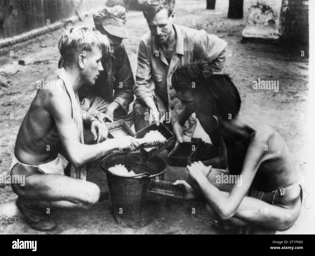 The British Army in Burma 1945 Liberated POWs at a Rangoon jail share a ...