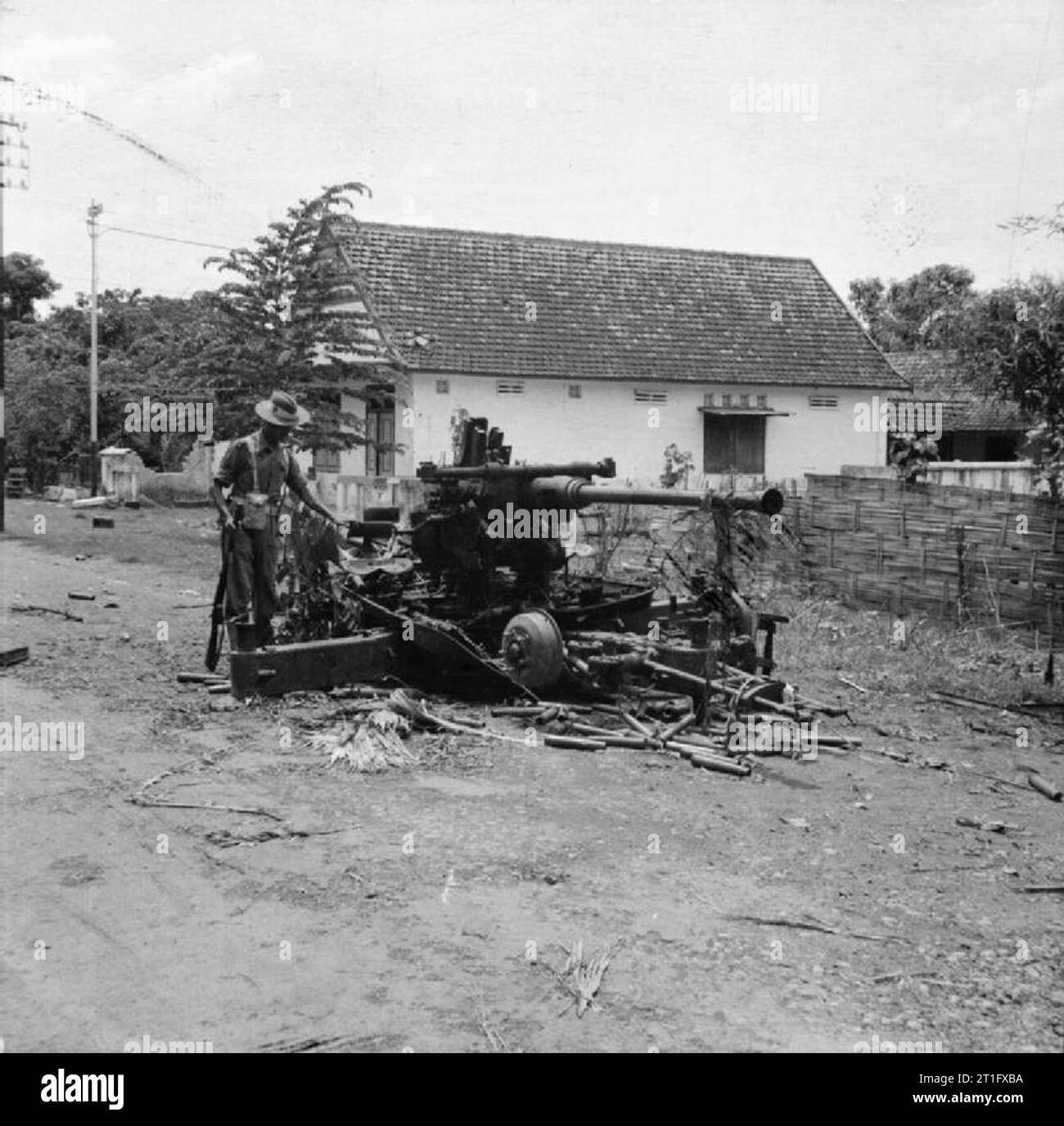 The British Occupation of Java A Soldier of the 5th Indian Division examines a bofors anti-aircraft gun knocked out by a British tank during fighting with Indonesian nationalists outside the town of Surabaya (Soerabaja). This gun was just one of many weapons handed over to the Indonesians rather than the British following the Japanese surrender. Stock Photo