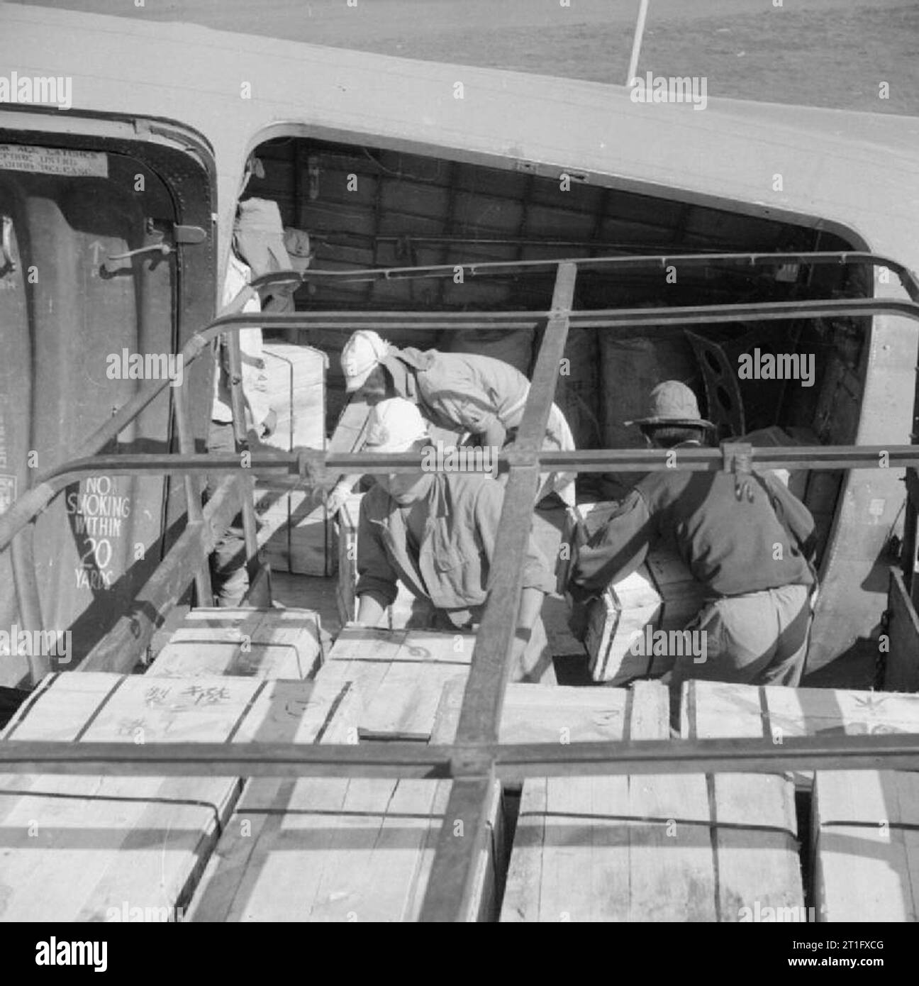 The British Occupation of Java Japanese prisoners of war load a Dakota aircraft of 31 Squadron, Royal Air Force, with food supplies ready for a flight to the city of Bandoeng. Due to ambushes and sabotage by Indonesian nationalists on the roads between Batavia and Bandoeng, the only secure supply route to the latter city was by air. Stock Photo