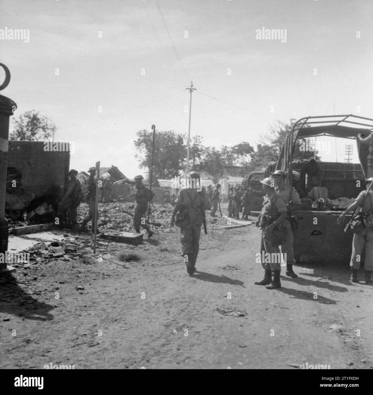 The British Occupation of Java Men of the 4/7th Rajputs in Bekassi during a reconnaissance in force to locate positions held by Indonesian nationalists. The damage to the buildings was mostly caused by 2 inch mortars with which the Rajputs replied to fire from Indonesian snipers. Stock Photo