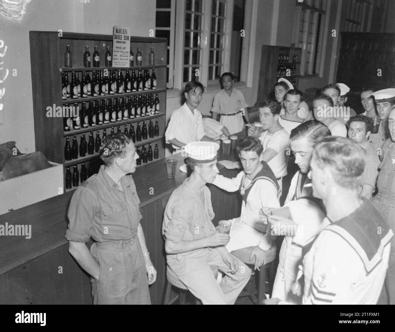 The British Reoccupation of Singapore British servicemen at the bar of the newly opened NAAFI canteen in Raffles Place, Singapore. The canteen was known as the 'Shackle Club.' Stock Photo