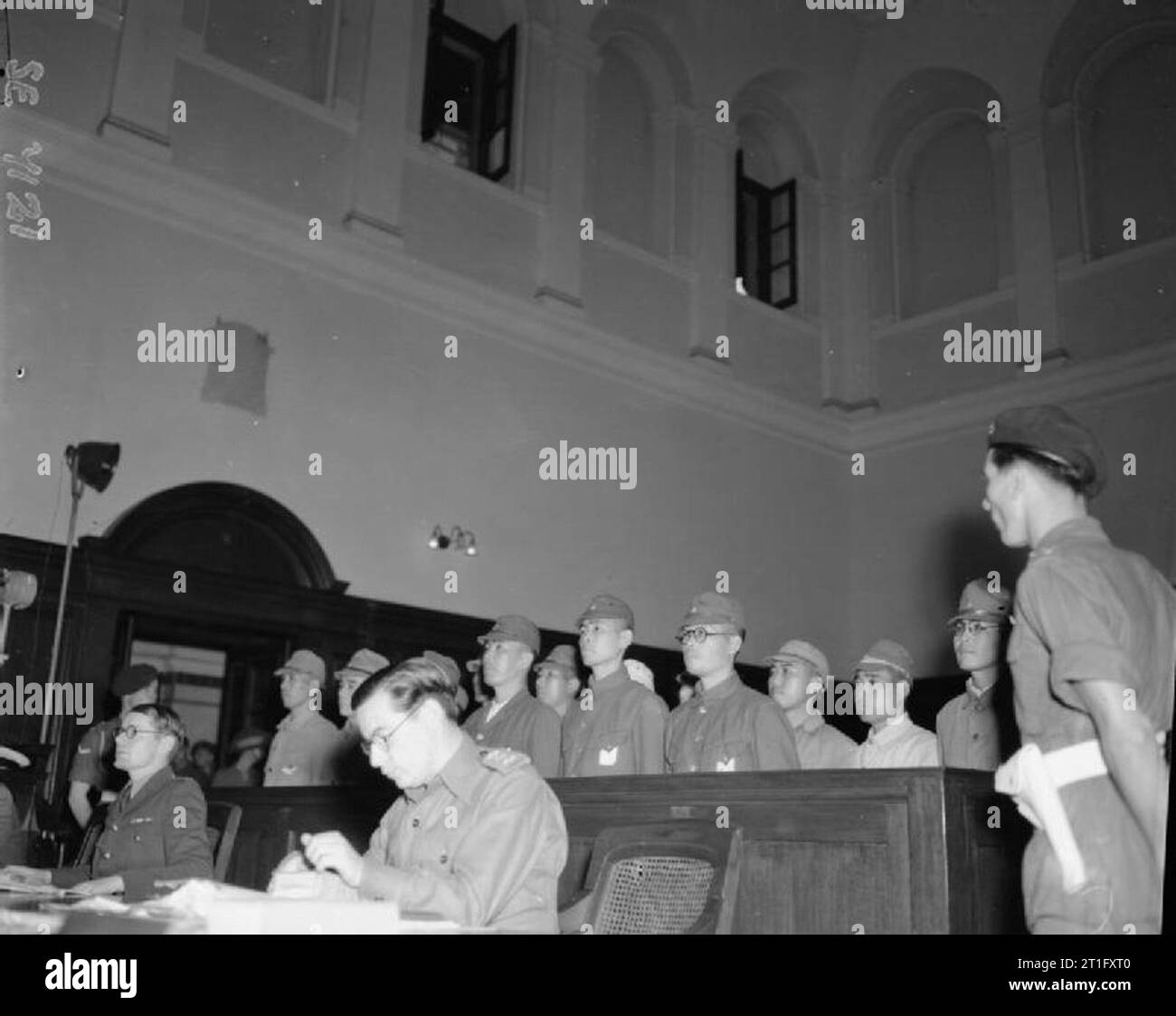 The Trial of Japanese War Criminals in Hong Kong Fifteen Japanese prisoners in the dock during the first war crimes trial in Hong Kong. These men were accused of atrocities on Luntau Island. Stock Photo