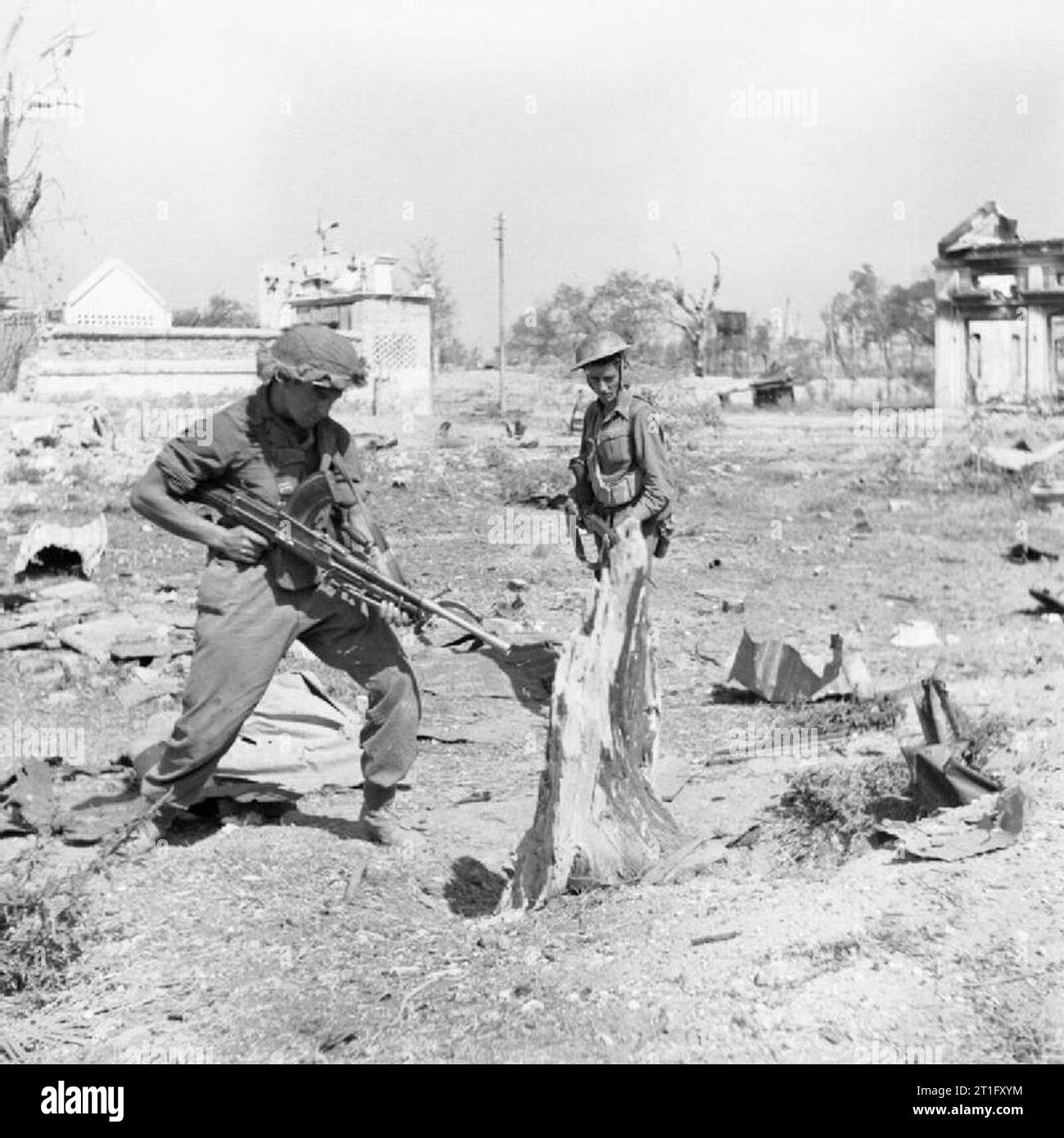 Troops of the West Yorkshire Regiment warily search Japanese dugouts in ...