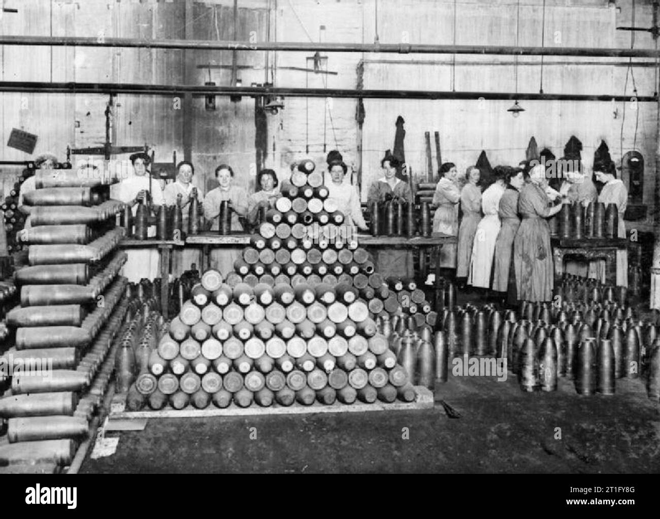 Industry during the First World War Female munitions workers put the finishing touches to high explosive and gas shells in a British factory during the First World War. Stock Photo