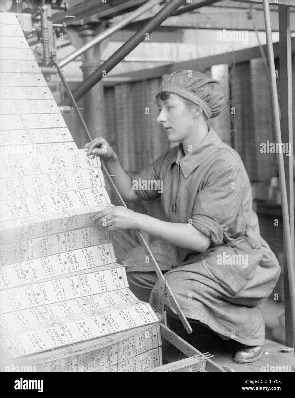 Industry during the First World War- Leicestershire A female worker changing jacquard cards in a lace machine in a Nottingham factory during the First World War. Stock Photo
