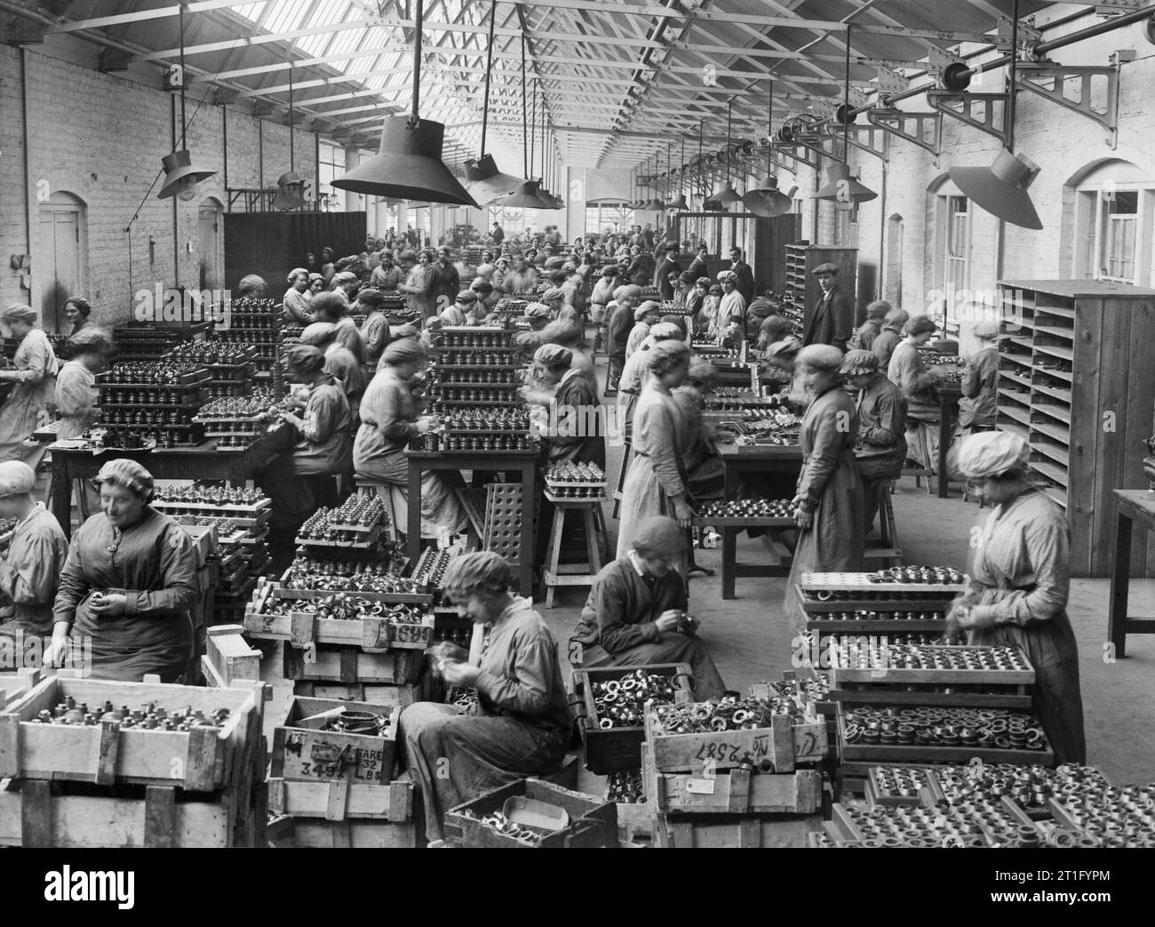 Women at work during the First World War Rows of women sit at benches as they arrange fuse heads in one of 'England's great gun factories', possibly Coventry Ordnance Works. Stock Photo
