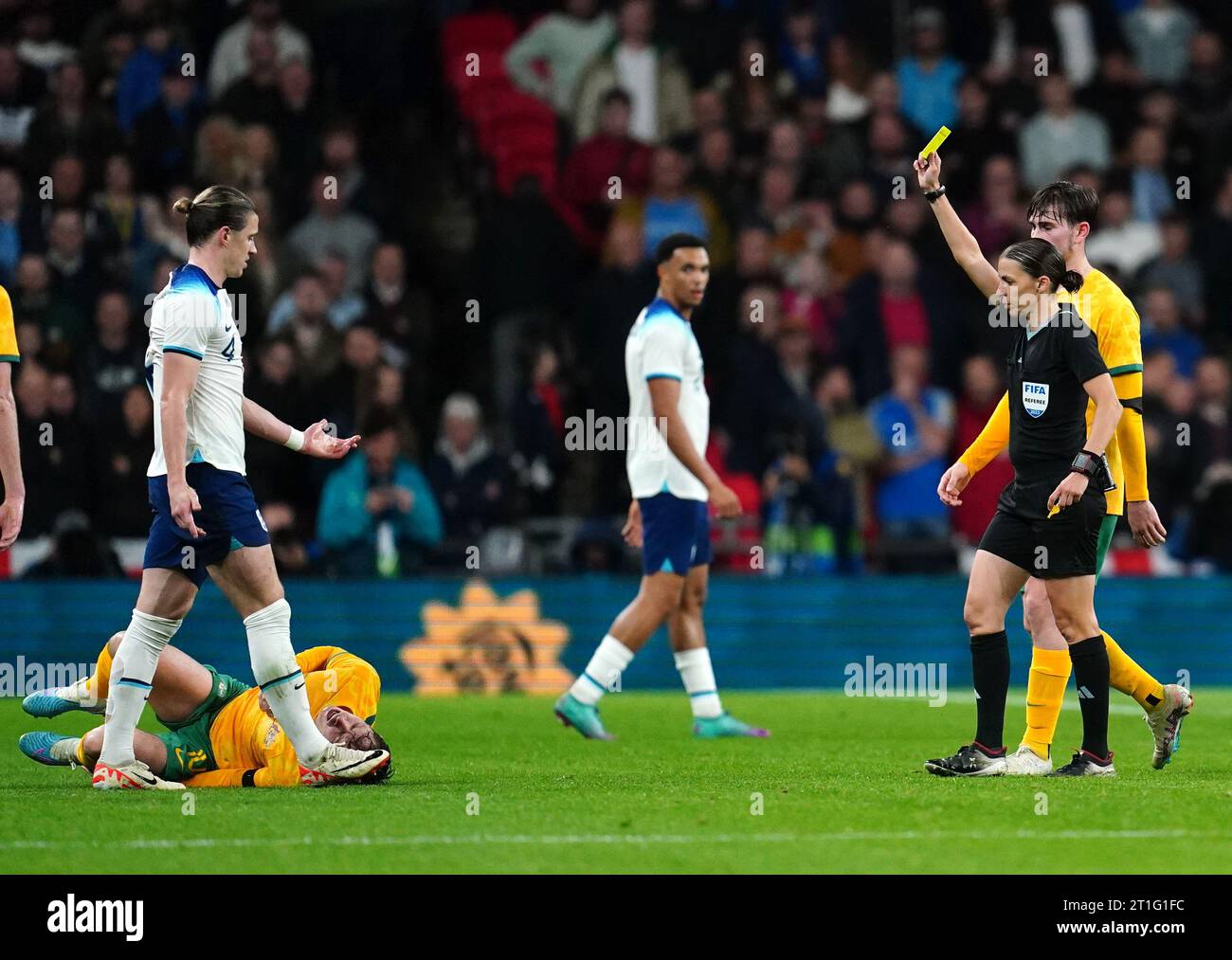 Referee Stephanie Frappart (right) shows a yellow card to England's Conor Gallagher during the international friendly match at Wembley Stadium, London. Frappert is the first woman to officiate a men's international game at Wembley. Picture date: Friday October 13, 2023. Stock Photo