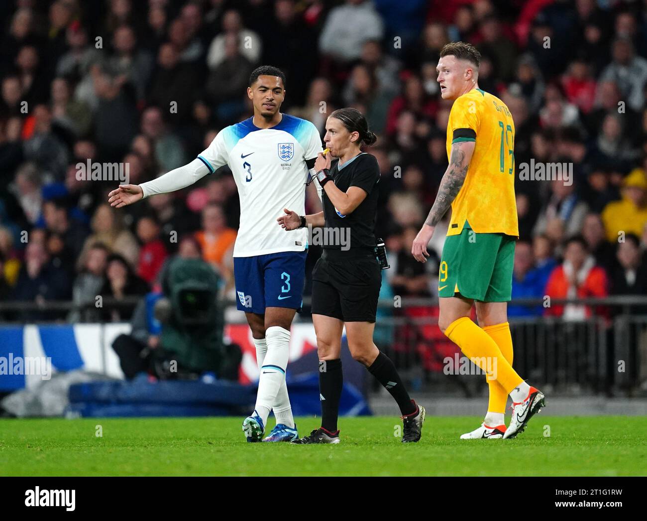 Referee Stephanie Frappart (centre) books England's Levi Colwill during the international friendly match at Wembley Stadium, London. Frappert is the first woman to officiate a men's international game at Wembley. Picture date: Friday October 13, 2023. Stock Photo