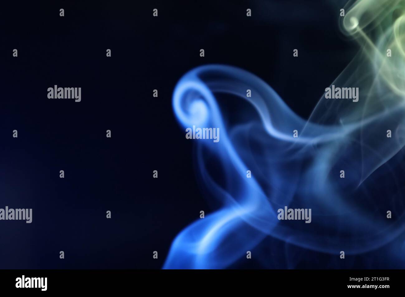Yellow and blue smoke on a dark background, colourful abstract, blue yellow fog, minimalistic background Stock Photo