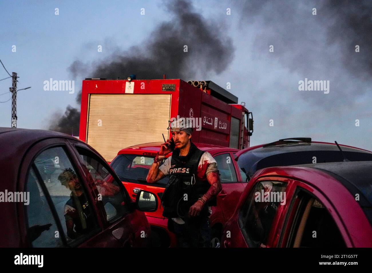 AFP cameraman Dylan Collins speaks on his mobile phone after he got ...