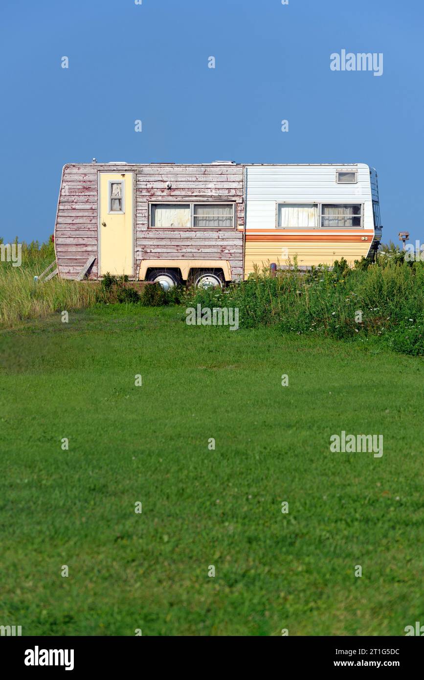 Old travel trailer in a field Stock Photo Alamy
