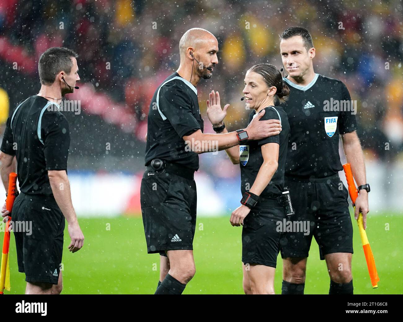 Referee Stephanie Frappart (centre right) speaks to fellow officials during the international friendly match at Wembley Stadium, London. Frappert is the first woman to officiate a men's international game at Wembley. Picture date: Friday October 13, 2023. Stock Photo