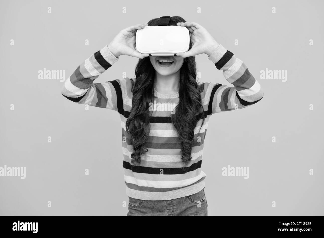 Teen girl wearing virtual reality goggles headset, vr. Connection, technology, new generation, progress concept. Virtual reality, 3D gadget. Happy tee Stock Photo
