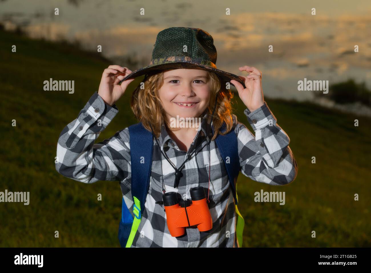 Child tourists with backpacks. Adventure, travel, and tourism concept. Kid walking with backpacks on nature. Little explorer on trip Stock Photo
